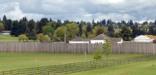 Image of the reconstructed stockade at Fort Vancouver and Pearson Air Museum looking northeast from the Land Bridge.